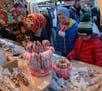 Candy canes and plastic cones filled with candies draw customers to a vendor&#x2019;s booth at the Gendarmenmarkt Christmas market in Berlin, 2016. Ph