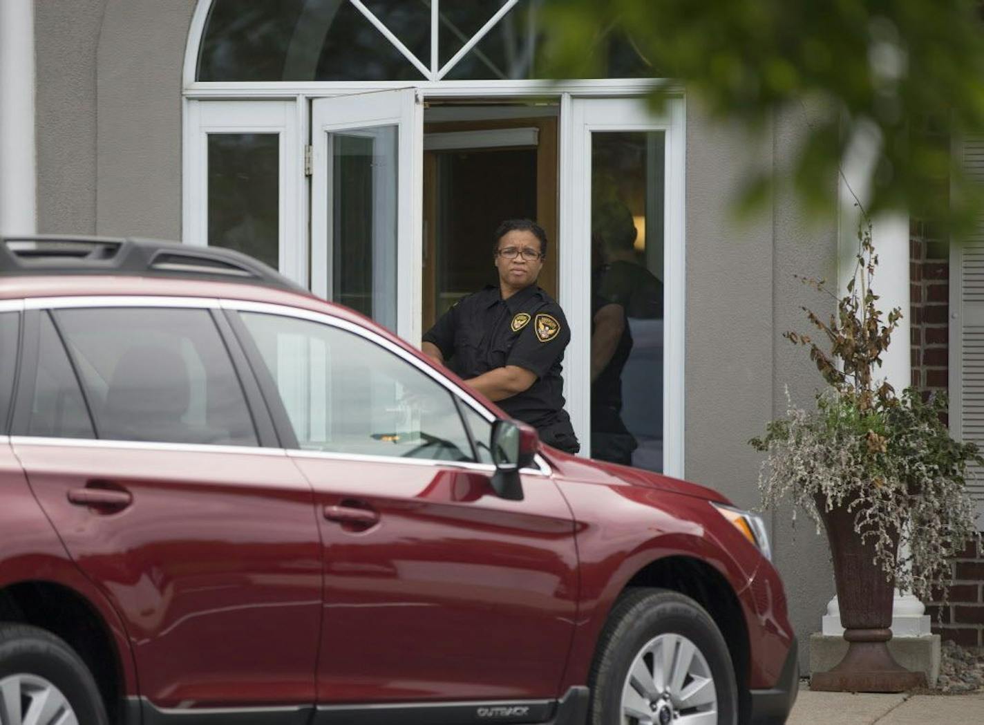 Security stood outside Dr. Walter Palmer's office River Bluff Dental as it reopened after Dr. Palmer was identified to have been the hunter who shot Cecil the lion in Zimbabwe this summer, on Monday, August 17, 2015 in Bloomington, Minn.