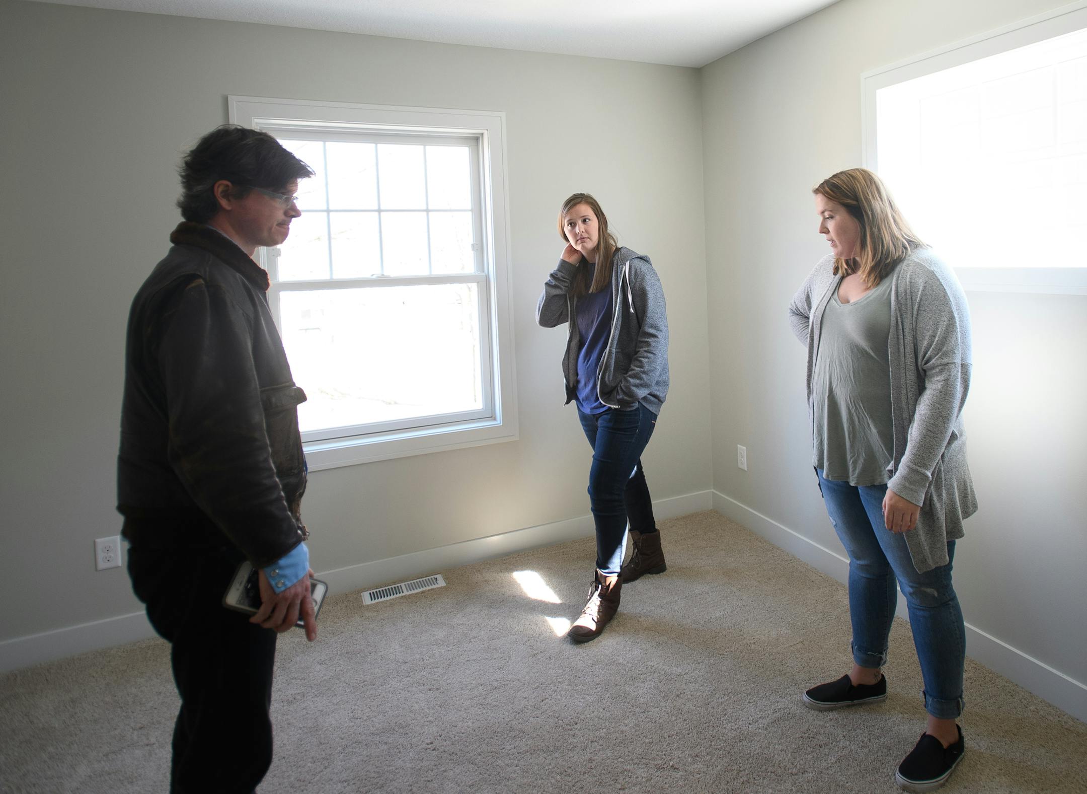 Friends Sami Caswell, right, and Rachael Drago, both from Minneapolis, were given a tour of an almost-completed home in northeast Minneapolis by realtor and lot owner Chris Harrington Friday afternoon. ] AARON LAVINSKY &#xef; aaron.lavinsky@startribune.com Housing construction -apartments and single-family houses - in the Twin Cities metro soared during March, according to a monthly report from the Builders Association of the Twin Cities. Realtor Chris Harrington showed prospective buyers an alm