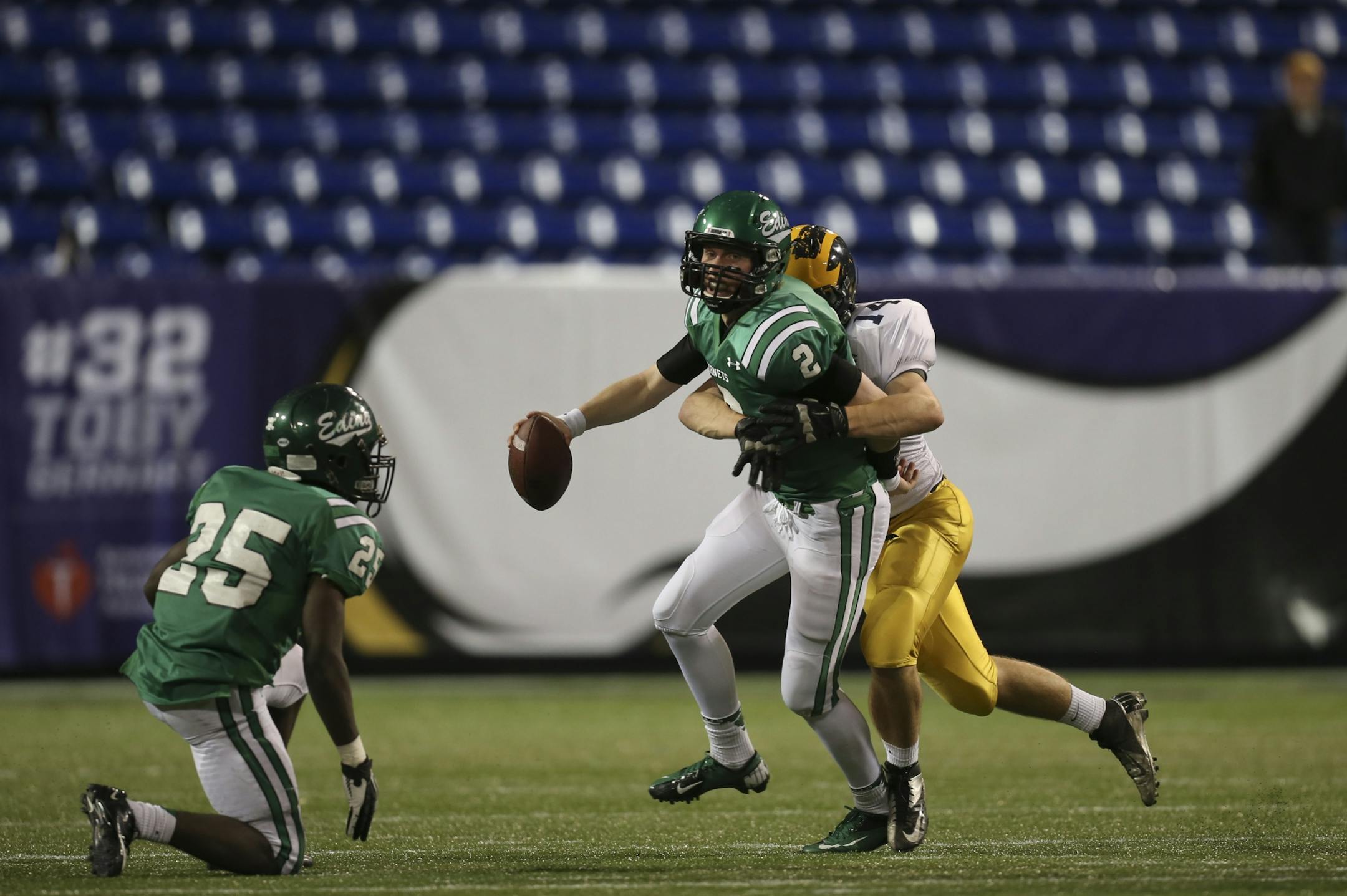 Edina quarterback Mark Handberg is sacked by Rosemount's Nate Sackett