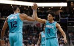 Charlotte Hornets' Jeremy Lamb (3) celebrates with Dwight Howard (12) after a basket against the Atlanta Hawks during the second half of an NBA basket