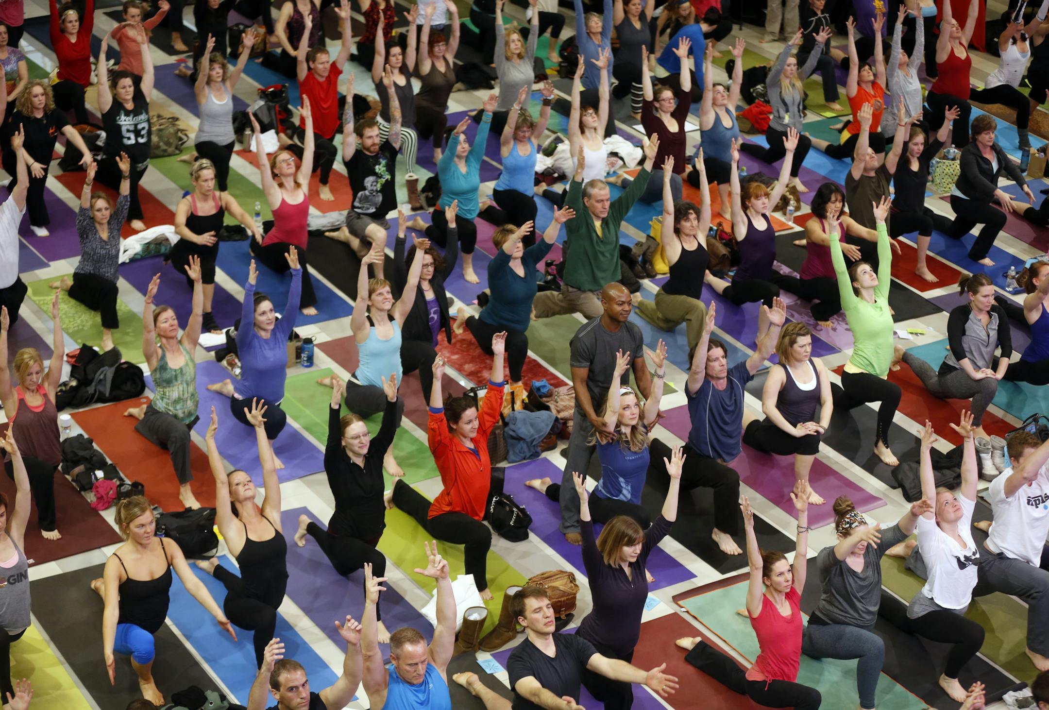 At the Mall of America rotunda, about 300 yoga practitioners joined for a workout sponsored by various studios in the vibrant Minneapolis yoga community.] rtsong-taatarii@startribune.com