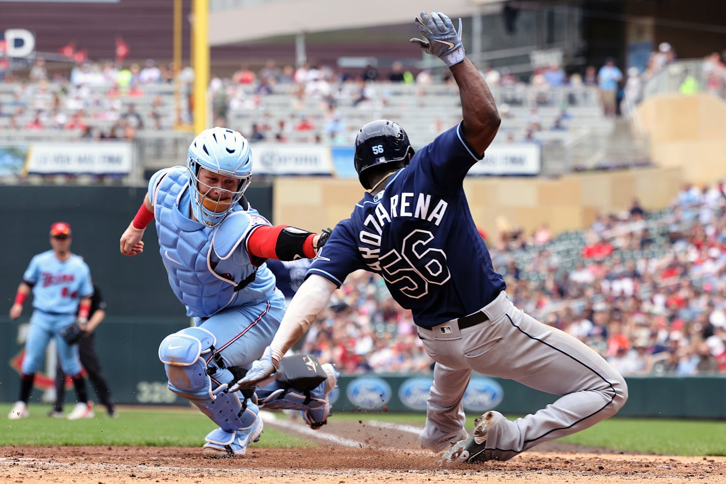 Tampa Bay Rays' Randy Arozarena scores against Minnesota Twins catcher Ryan Jeffers (27) during the fourth inning of a baseball game, Sunday, June 12, 2022, in Minneapolis. (AP Photo/Stacy Bengs)