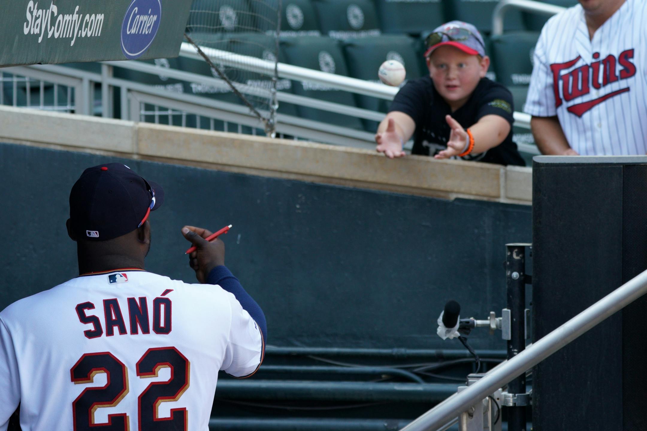 Minnesota Twins third baseman Miguel Sano (22) threw an autographed ball to a young fan after losing to the Atlanta Braves.