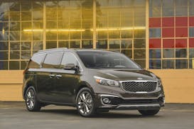 This photo provided by Kia shows the 2017 Kia Sedona, an example of a "dark horse" minivan that can represent a less expensive but feature-filled alte