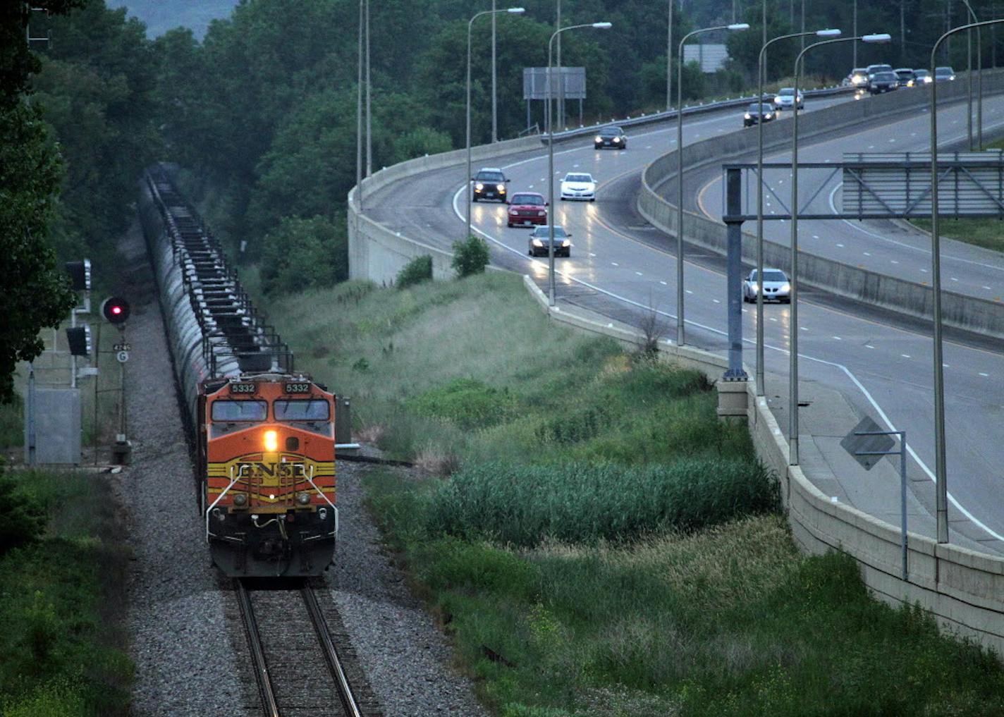 In this July 25, 2014 photo, an oil train moves through the area South of St Paul, Minn. Railroad documents released by the state Department of Public Safety show about 50 trains carrying crude oil from North Dakota are passing through Minnesota each week. The documents obtained by The Associated Press were first reported Saturday, July 26 by the Star Tribune. (AP Photo/The Star Tribune, Connor Lake) MANDATORY CREDIT; ST. PAUL PIONEER PRESS OUT; MAGS OUT; TWIN CITIES LOCAL TELEVISION OUT