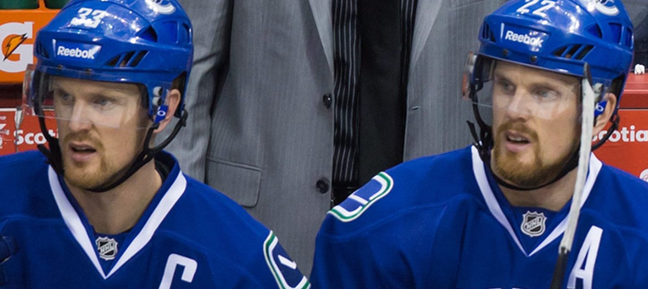 Vancouver Canucks coach Willie Desjardins, top right, shouts from the bench as assistant coach Glen Gulutzan, left, and players seated from left to right, Henrik Sedin, of Sweden; Daniel Sedin, of Sweden; Alex Burrows and Linden Vey watch play during the third period of an NHL hockey game against the New York Islanders on Tuesday, Jan. 6, 2015, in Vancouver, British Columbia. (AP Photo/The Canadian Press, Darryl Dyck)