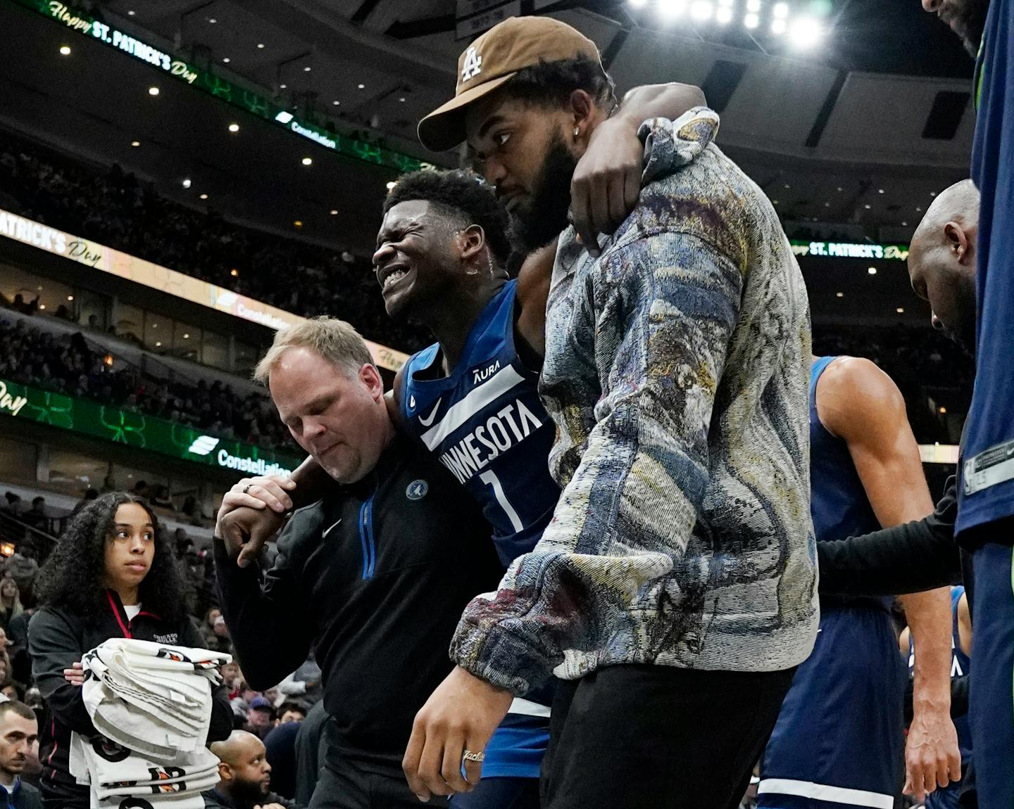 Minnesota Timberwolves guard Anthony Edwards (1) leaves the court after an injury during the first half of the team's NBA basketball game against the Chicago Bulls in Chicago, Friday, March 17, 2023. (AP Photo/Nam Y. Huh)