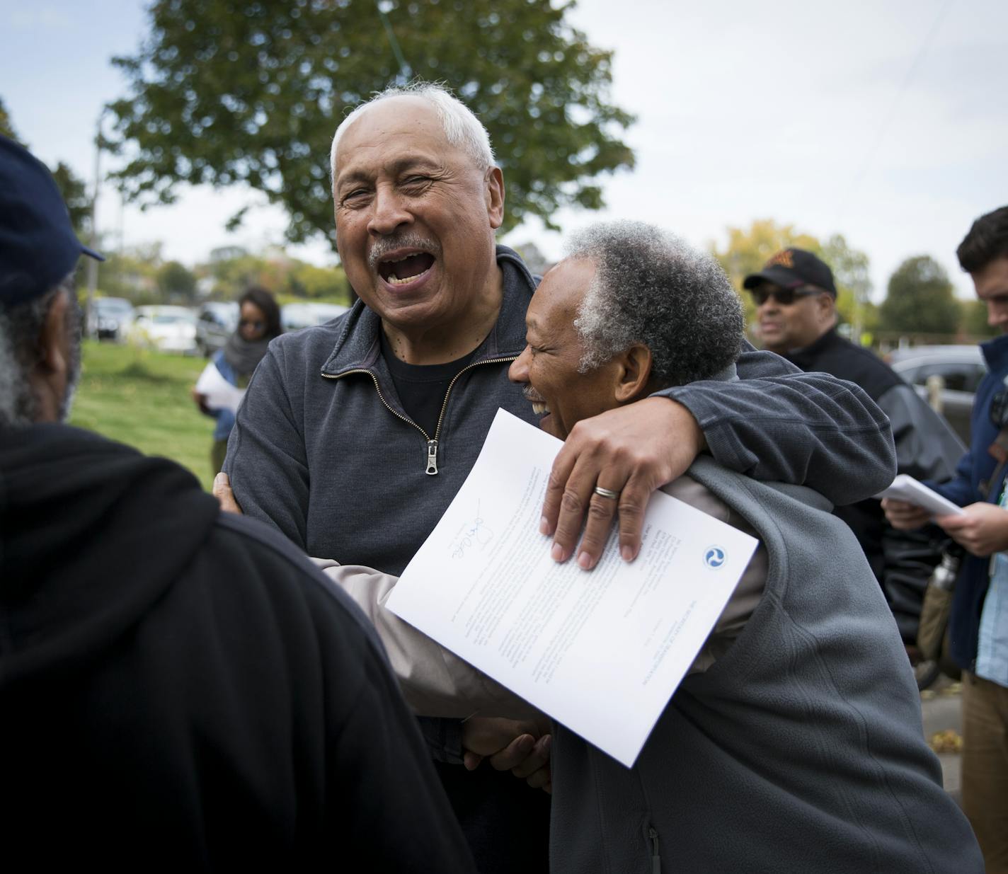 Frank White, left, hugged Ron Dodd as they ran into each other after 30 years at a groundbreaking ceremony for Rondo Commemorative Plaza on Oct. 14, 2016.