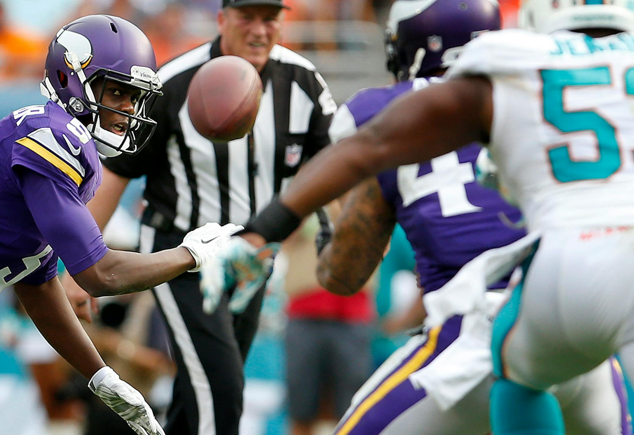 Teddy Bridgewater (5) attempted a pass to Matt Asiata (44) in the third quarter. The pass bounced off of Asiata and was intercepted by Derrick Shelby (79).