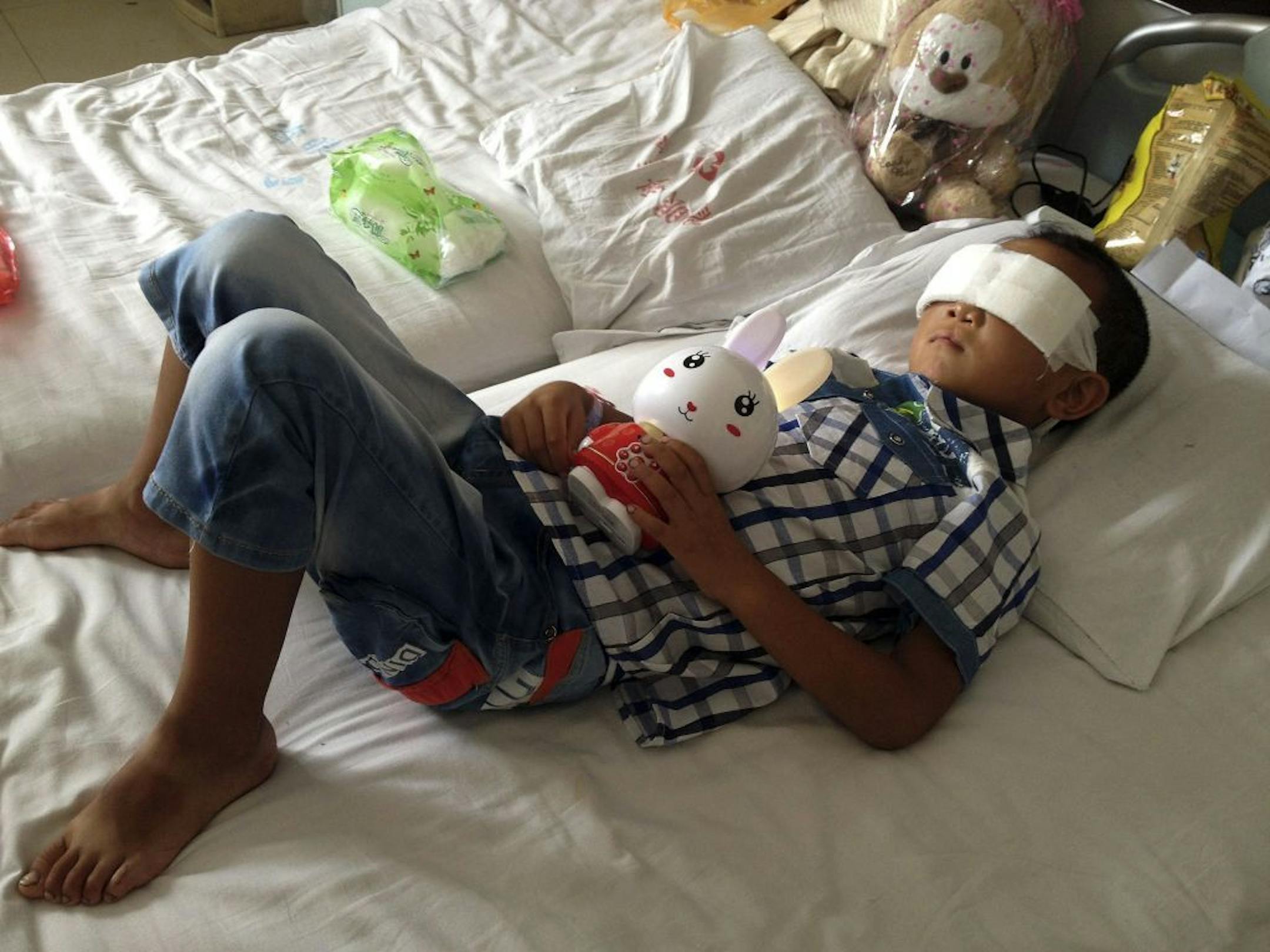 Guo Bin recuperates from an attack in the rural area of Linfen city that left him blind, in a hospital in Taiyuan in northwest China's Shanxi province on Wednesday, Aug. 28, 2013.