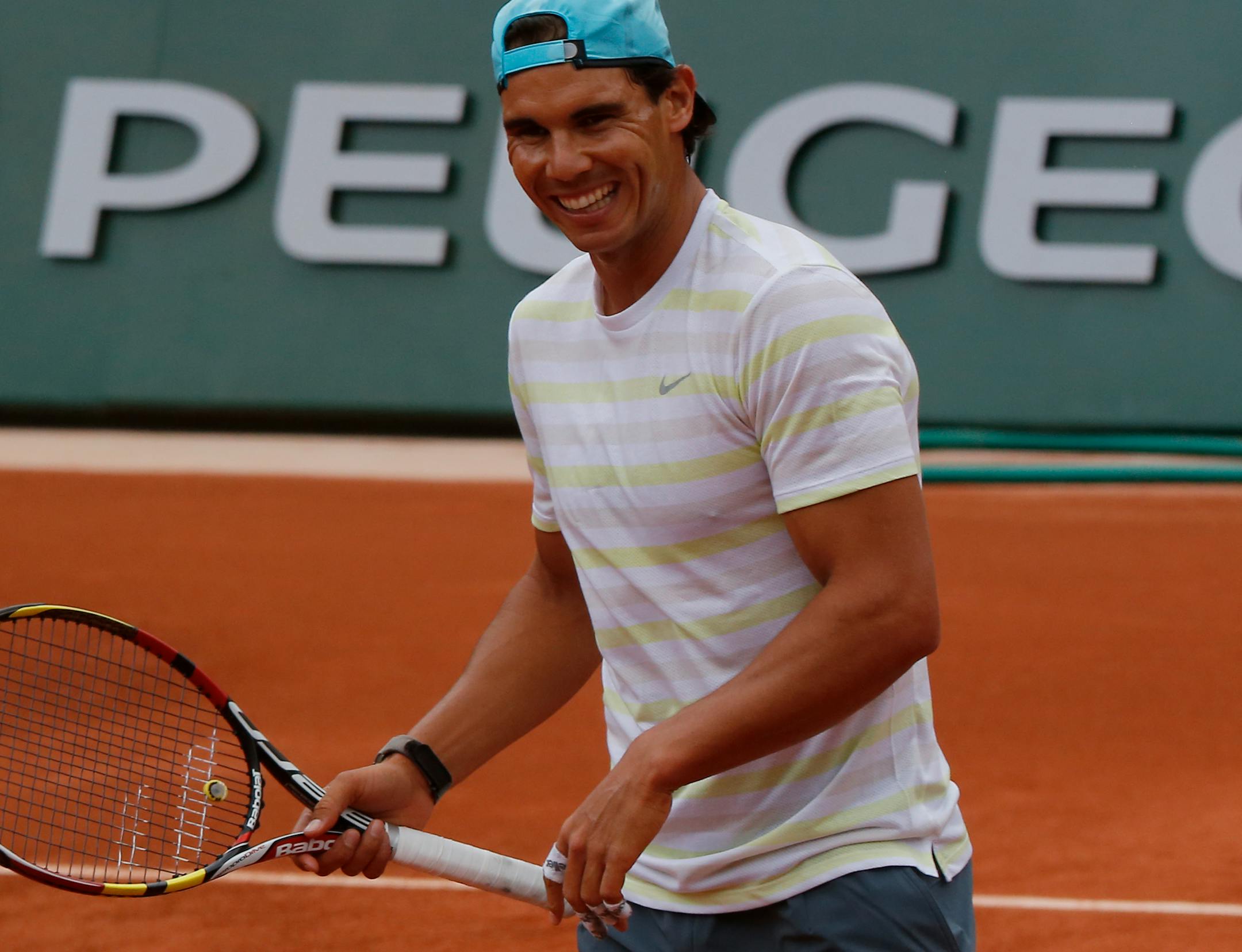 Defending champion Spain's Rafael Nadal smiles during a training session for the French Open tennis tournament, at the Roland Garros stadium in Paris, Friday, May 23, 2014. The French Open tennis championship will start Sunday. (AP Photo/Bertrand Combaldieu)