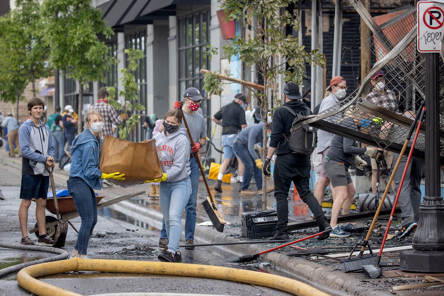 Hundreds of volunteers showed up to clean up along University Avenue, organized by Hamline Midway Coalition, on Friday in St. Paul.