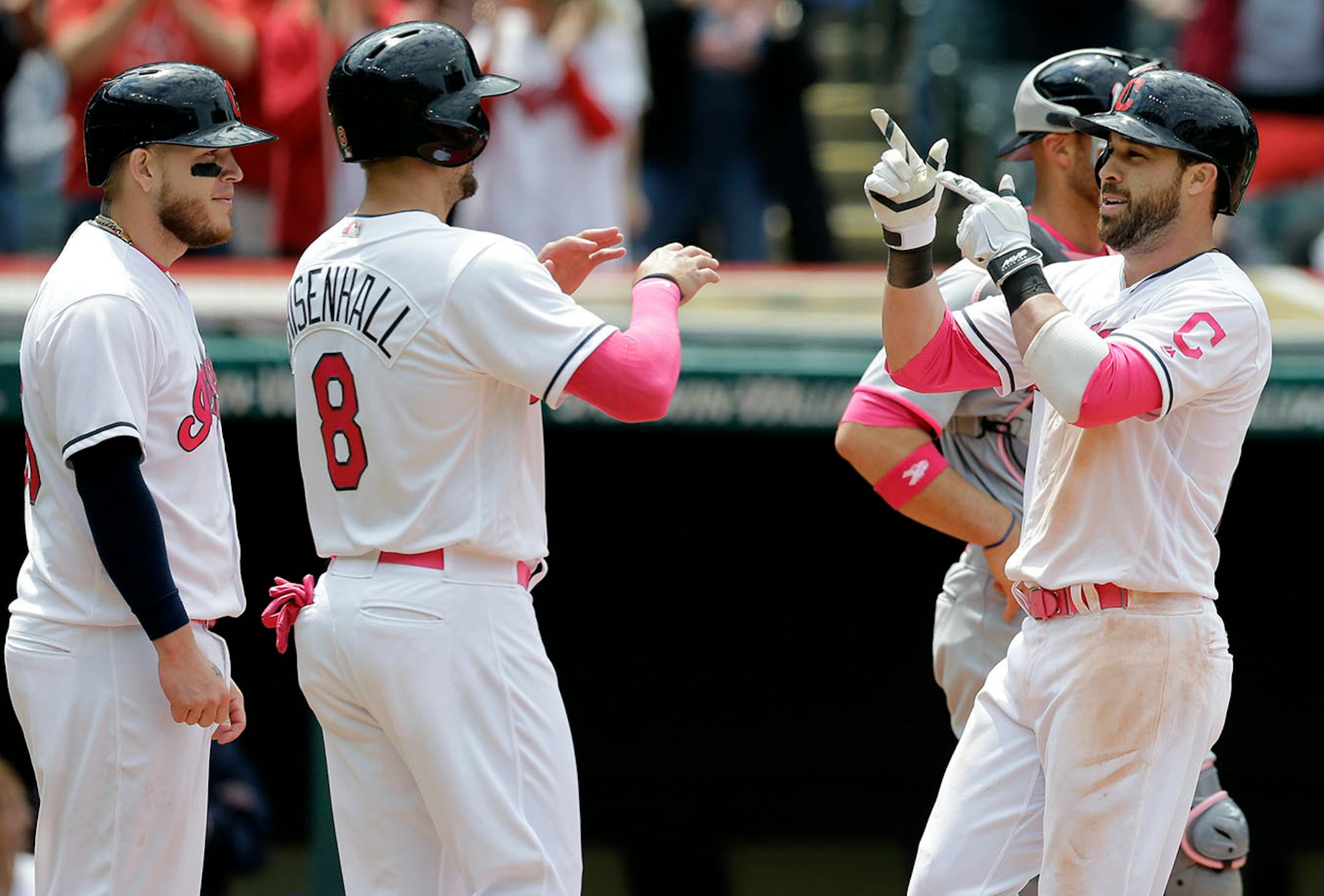 Cleveland Indians' Jason Kipnis, right, is congratulated by Lonnie Chisenhall, center, and Roberto Perez after Kipnis hit a three-run home run off Minnesota Twins' Adam Wilk in the third inning of a baseball game, Sunday, May 14, 2017, in Cleveland. Chisenhall and Perez scored on the play.