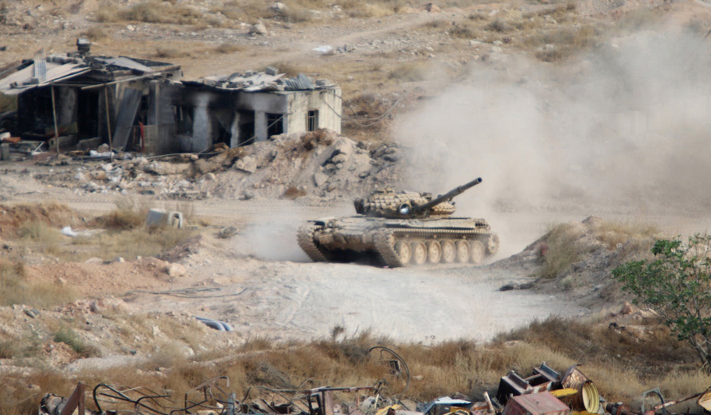 A Syrian tank fires in Harasta, northeast of Damascus, Syria, Thursday, Oct. 22, 2015. Syrian troops have been fighting rebels in the frontline district, which lies on the northeastern edge of Damascus and only few kilometers (miles) from the presidential palace, since 2013. Neither side has been able to make a breakthrough in the fighting, although state media has reported Syrian army advances in the last week as part of a major army offensive.(Alexander Kots/Komsomolskaya Pravda via AP) ORG XM