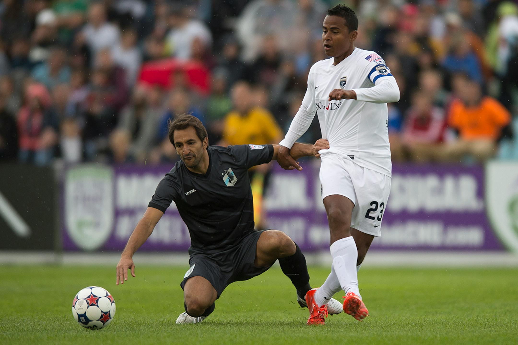 Minnesota United FC midfielder Juliano Vicentini, left, grabbed the jersey of Jacksonville Armada FC's Jaime Castrillon as he fell to the ground in the first half on Saturday. ] Aaron Lavinsky • aaron.lavinsky@startribune.com Minnesota United FC played Jacksonville on Saturday, May 23, 2015 at the National Sports Center in Blaine.