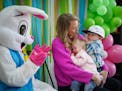 Sarah Urban and her children Mason, 2, and Kinley, 18 months, sit next to the Easter Bunny for a photo.