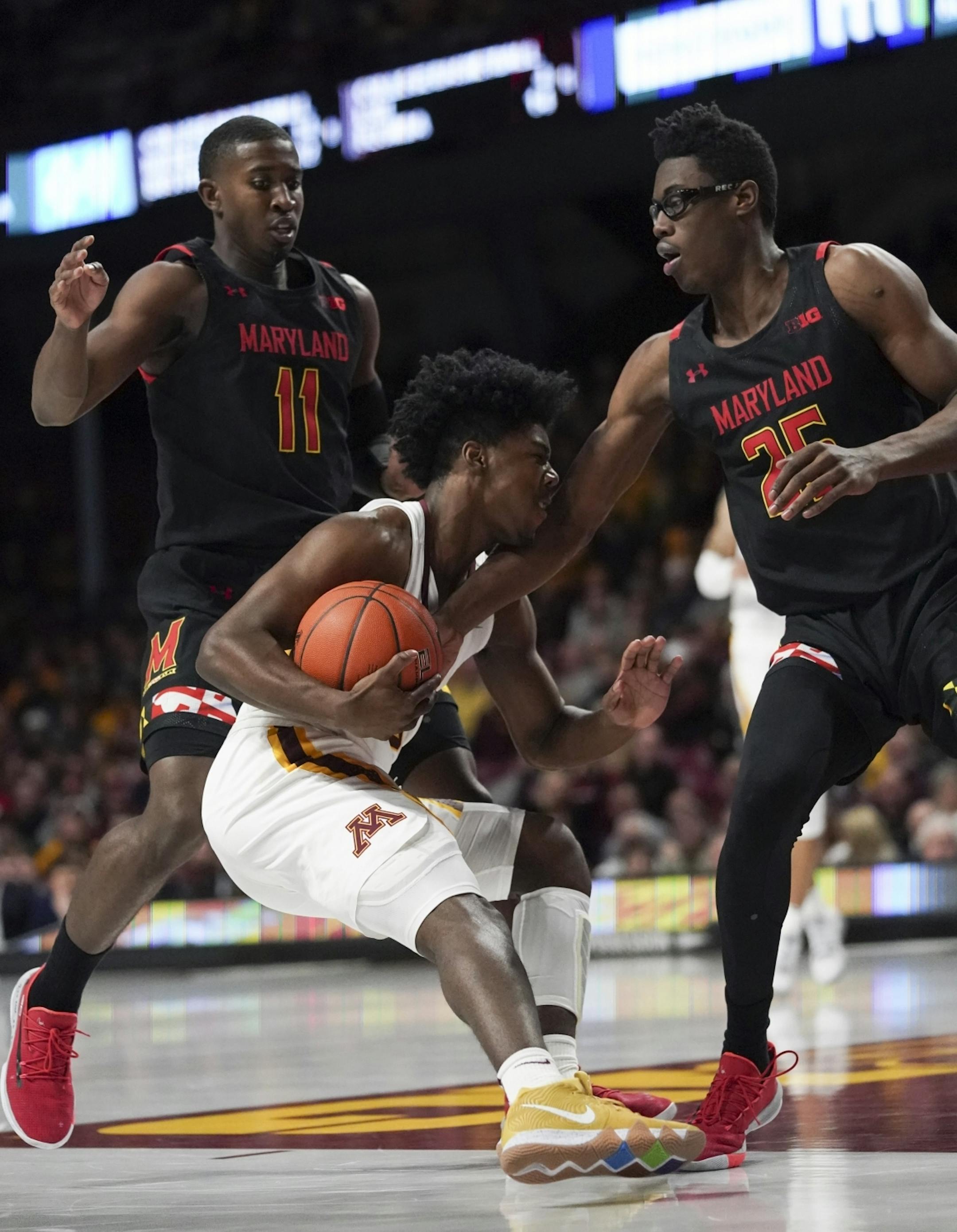 Minnesota Gophers guard Marcus Carr (5) got sandwiched between Maryland Terrapins guard Darryl Morsell (11) and Maryland Terrapins forward Jalen Smith (25) before squeezing his way out in the first half.
