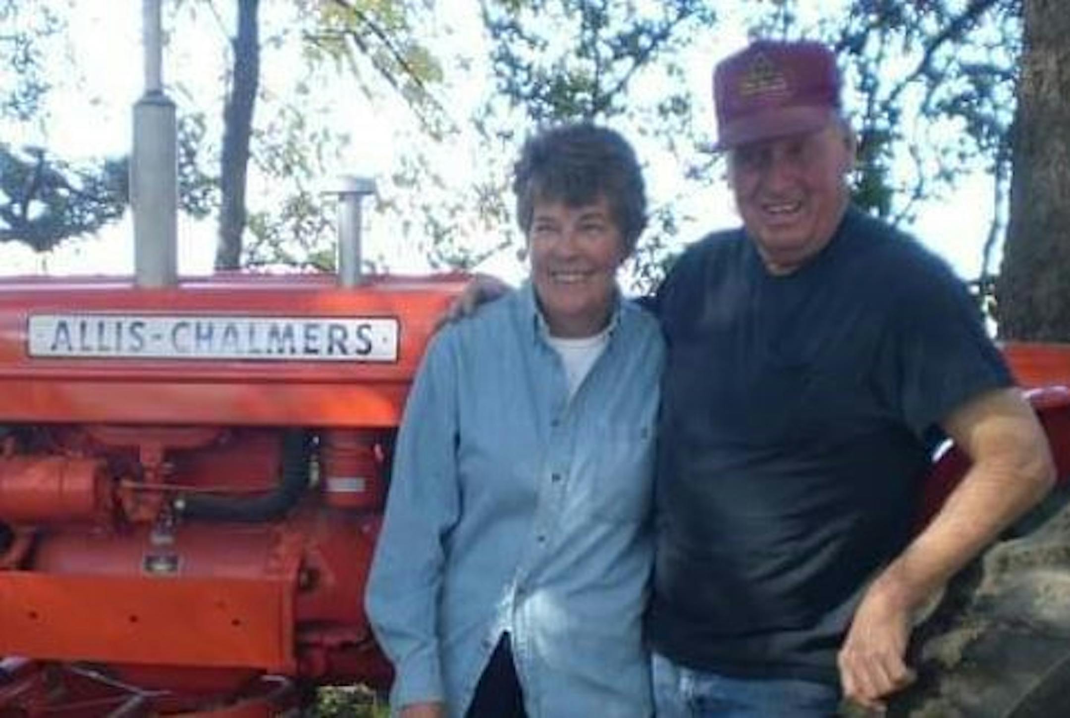 Robert Mennen and wife Dianne Mennen, next to one of his cherished tractors.