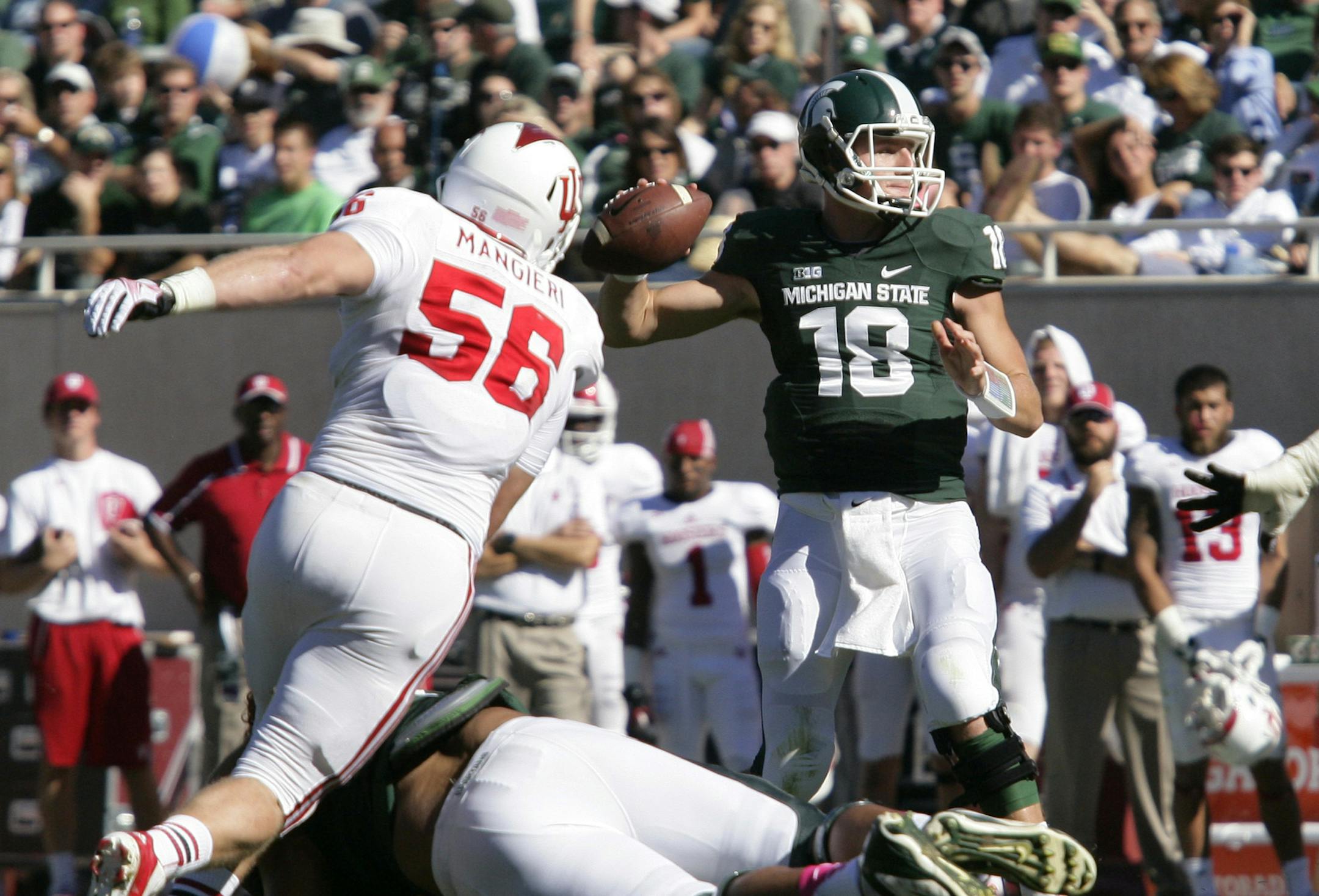 Michigan State quarterback Connor Cook (18) throws a pass as Indiana's Nick Mangieri (56) pursues during the second quarter of an NCAA college football game, Saturday, Oct. 12, 2013, in East Lansing, Mich. Michigan State won 42-28. (AP Photo/Al Goldis) ORG XMIT: MIN2013103118053270