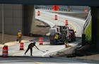 Workers put the the finishing touches on a key ramp leading to southbound I-35W from 10th Street and 4th Avenue South Wednesday. ] ANTHONY SOUFFLE &#x