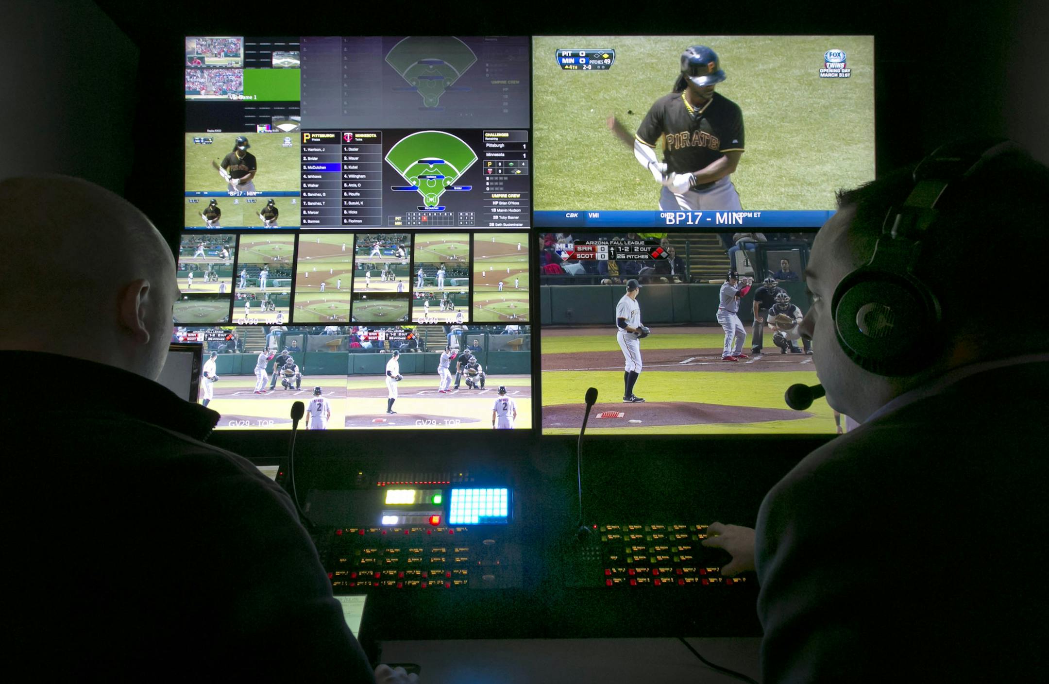 Two technicians work in a booth during a preview of Major League Baseball's Replay Operations Center, in New York, Wednesday, March 26, 2014
