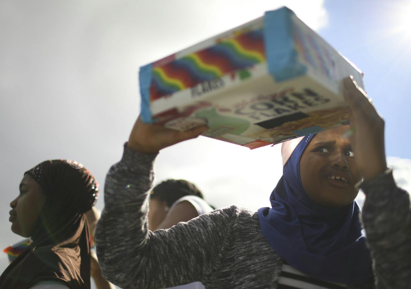 Birna Hassan, 9, tried to see the sun with the pinhole projector camera she made while testing it outside the Brooklyn Park Library. The Brooklyn Park Library's Teen Tech Squad led a workshop Thursday afternoon, August 10, 2017 for other kids on how to construct a pinhole projector camera from ordinary materials found around the house. The pinhole projectors they made could be used to safely view the upcoming solar eclipse.