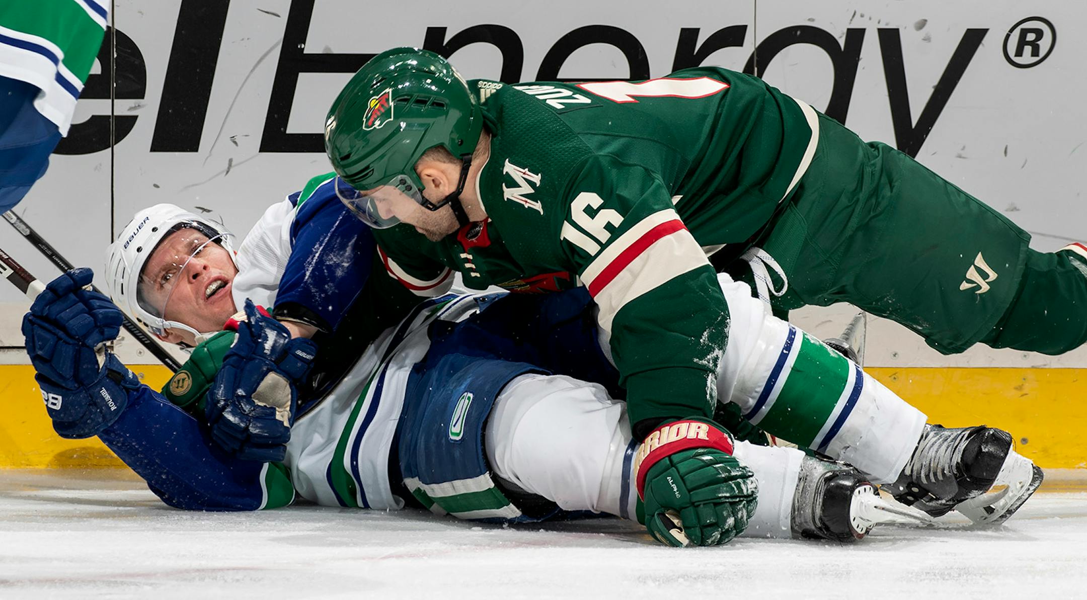Antoine Roussel (26) of the Vancouver Canucks and Jason Zucker (16) of the Minnesota Wild got tangled up in the second period.