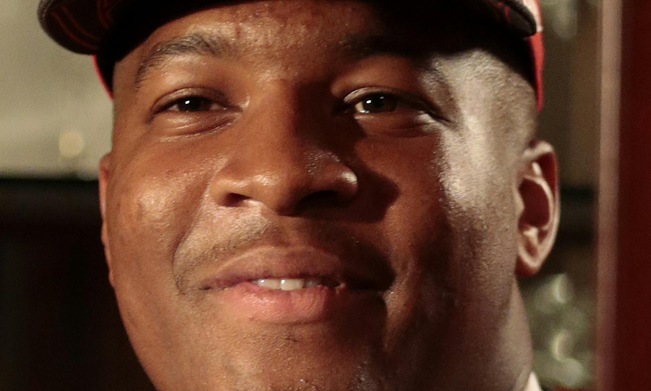 Jameis Winston poses with a Tamp Bay Buccaneers cap and NFL football after he was selected as the number one draft pick, Thursday, April 30, 2015, in Bessemer, Ala. (AP Photo/Butch Dill)