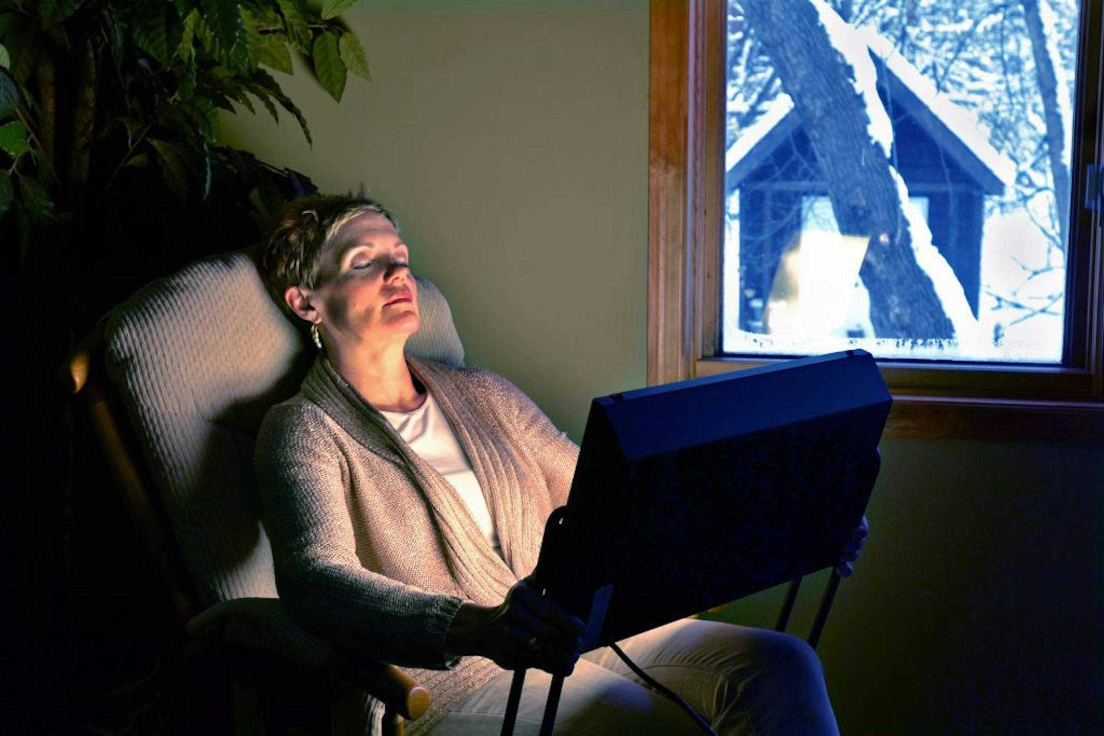 Barb Churchill, life coach and mentor, meditated in front of her light box in the bedroom.