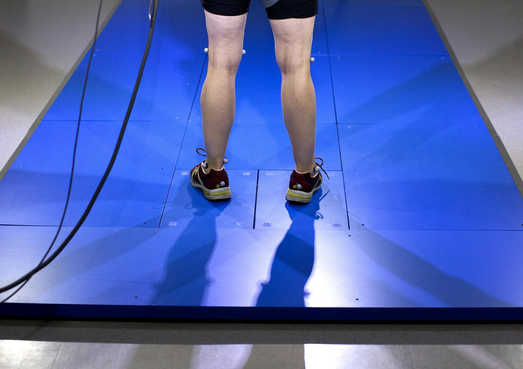 Liz Ogren, who was diagnosed with Parkinson's disease in 2007, stands on a weight-sensitive floor while wearing reflective markers on her body so that her gait can be tested in the Movement Disorders Laboratory at the University of Minnesota in Minneapolis April 25, 2014. (Courtney Perry/Special to the Star Tribune)