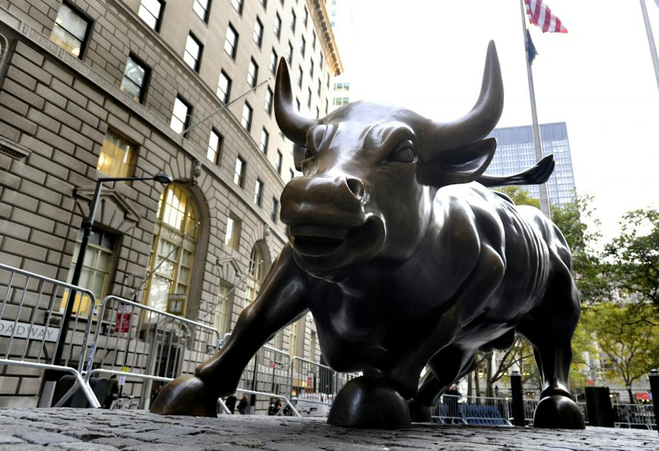 The Wall Street Bull, located in the financial district of New York City, on Thursday, November 3, 2011. The bronze sculpture, located in Bowling Green Park on Broadway and Main Street, was created by Arturo Di Modica and installed in 1989. In response to Occupy Wall Street demonstrations, the New York City police department now guards the bull around the clock, seven days a week.