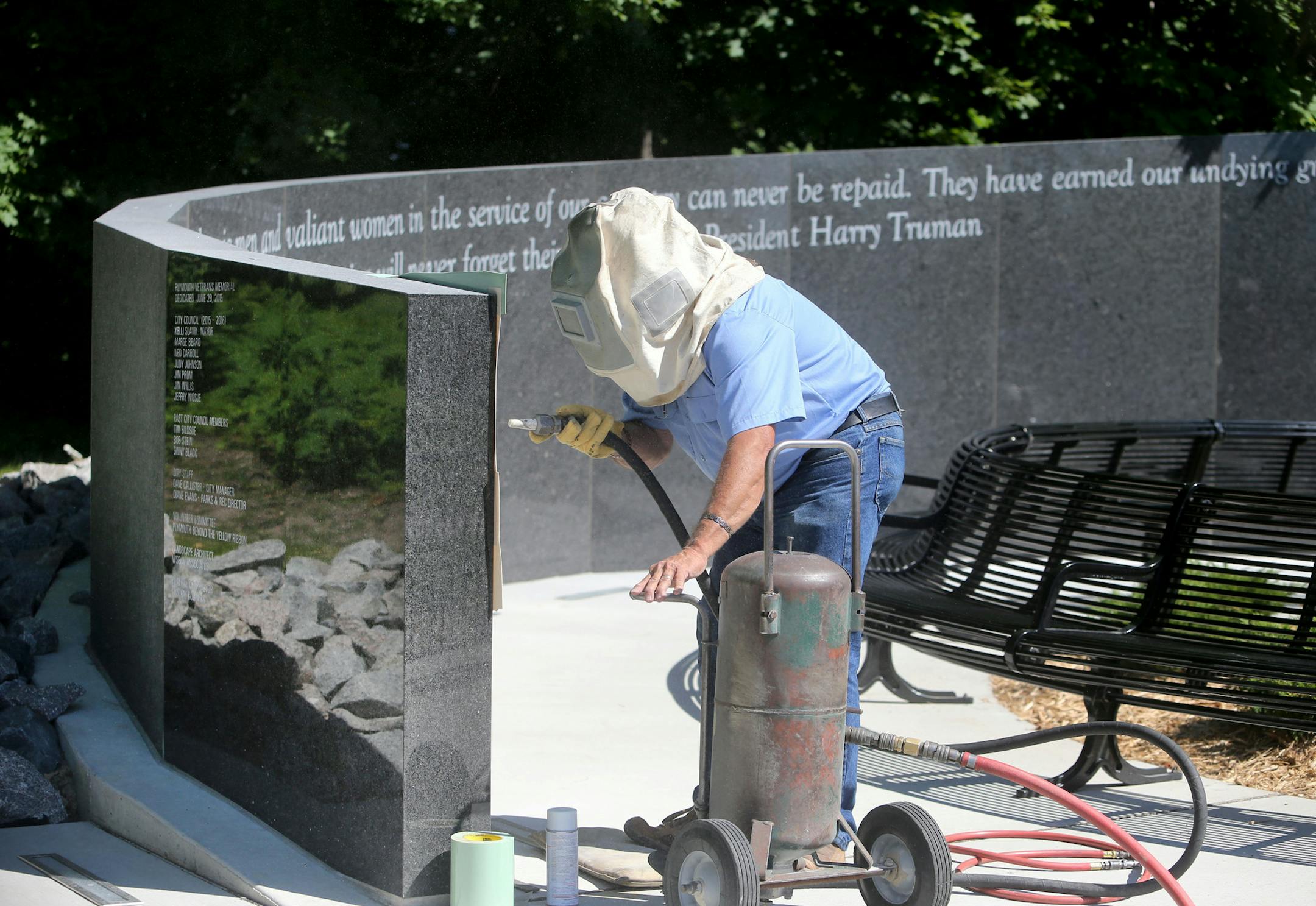 Engraver Wayne Winkelman, who owns and operates Winkelman Cemetery Lettering in St. Cloud, used a sand blaster to engrave the names of the first to go onto the Minnesota black granite Memorial Tuesday, June 16, 2015, near the southwest corner of the Hilde Performance Center at 3500 Plymouth Blvd. in Plymouth, MN. ](DAVID JOLES/STARTRIBUNE)djoles@startribune.com Plymouth is honoring area veterans with a new memorial that will be unveiled this month. Crews started work on engraving names of local
