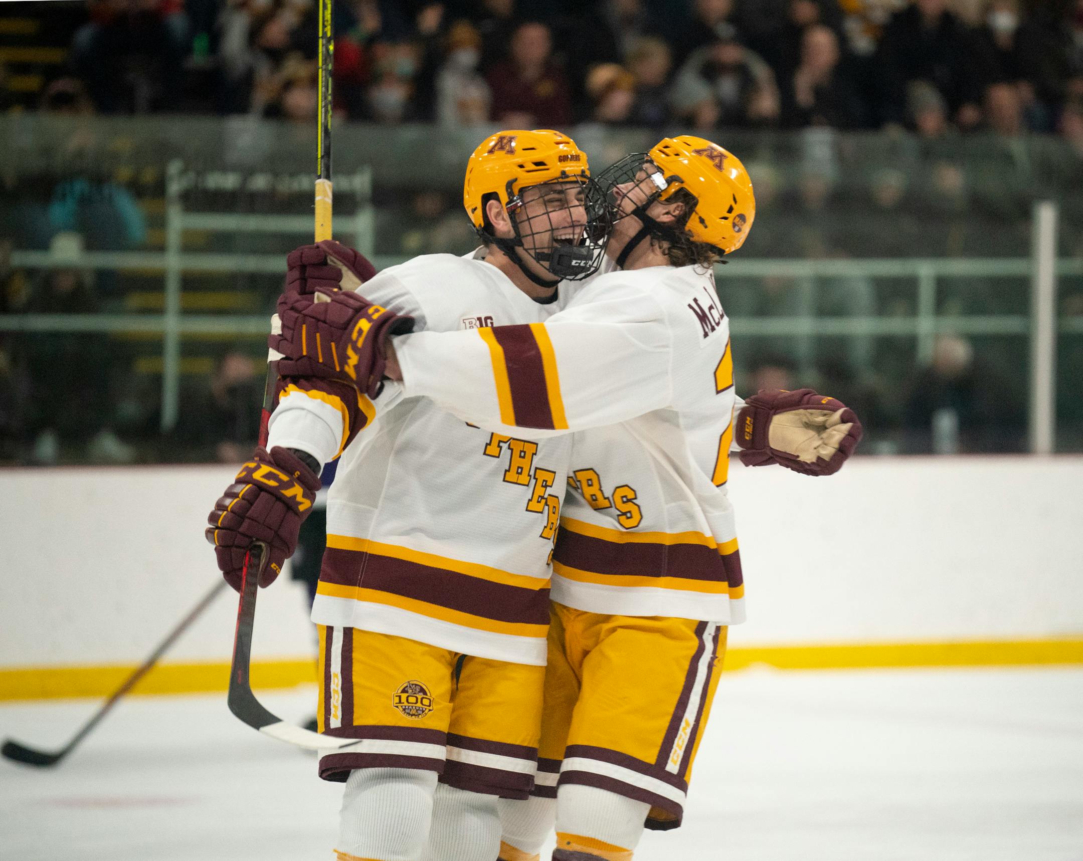 Gophers forward Blake McLaughlin (27) wrapped up Gophers defenseman Matt Denman (5) in a hug after he scored an empty net goal in the third period Sunday afternoon, Jan. 2, 2022 at Doug Woog Arena in South St. Paul.