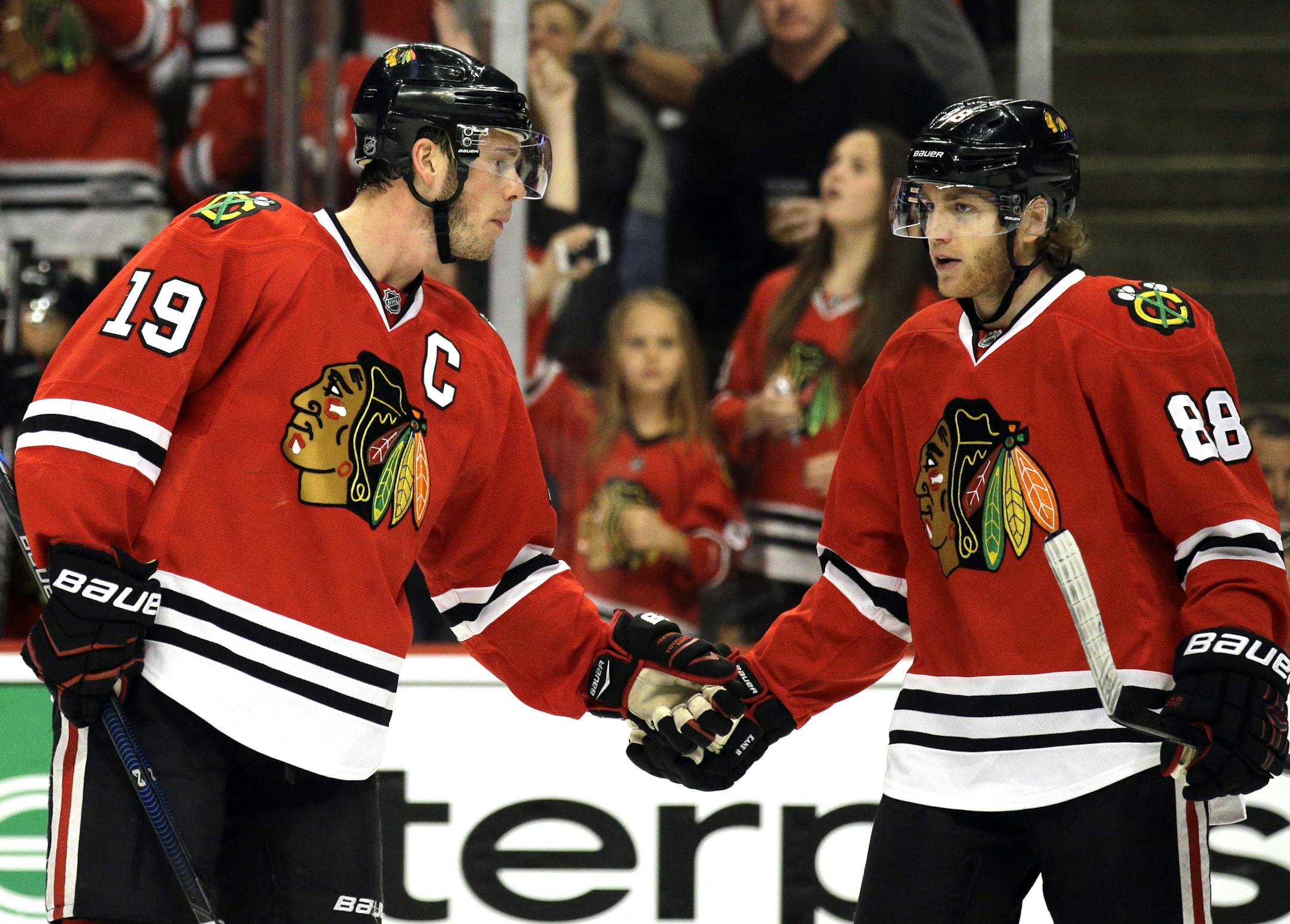 ADVANCE FOR WEEKEND EDITIONS, MAY 15-17 - FILE - In this April 25, 2015, file photo, Chicago Blackhawks center Jonathan Toews, left, celebrates with right wing Patrick Kane after scoring a goal during the first period in Game 6 of an NHL Western Conference hockey playoff series against the Nashville Predators in Chicago. Ryan Getzlaf and Corey Perry broke into the Anaheim Ducks' lineup together and won the Stanley Cup together. So did Chicago's Jonathan Toews and Patrick Kane. (AP Photo/Nam Y. H