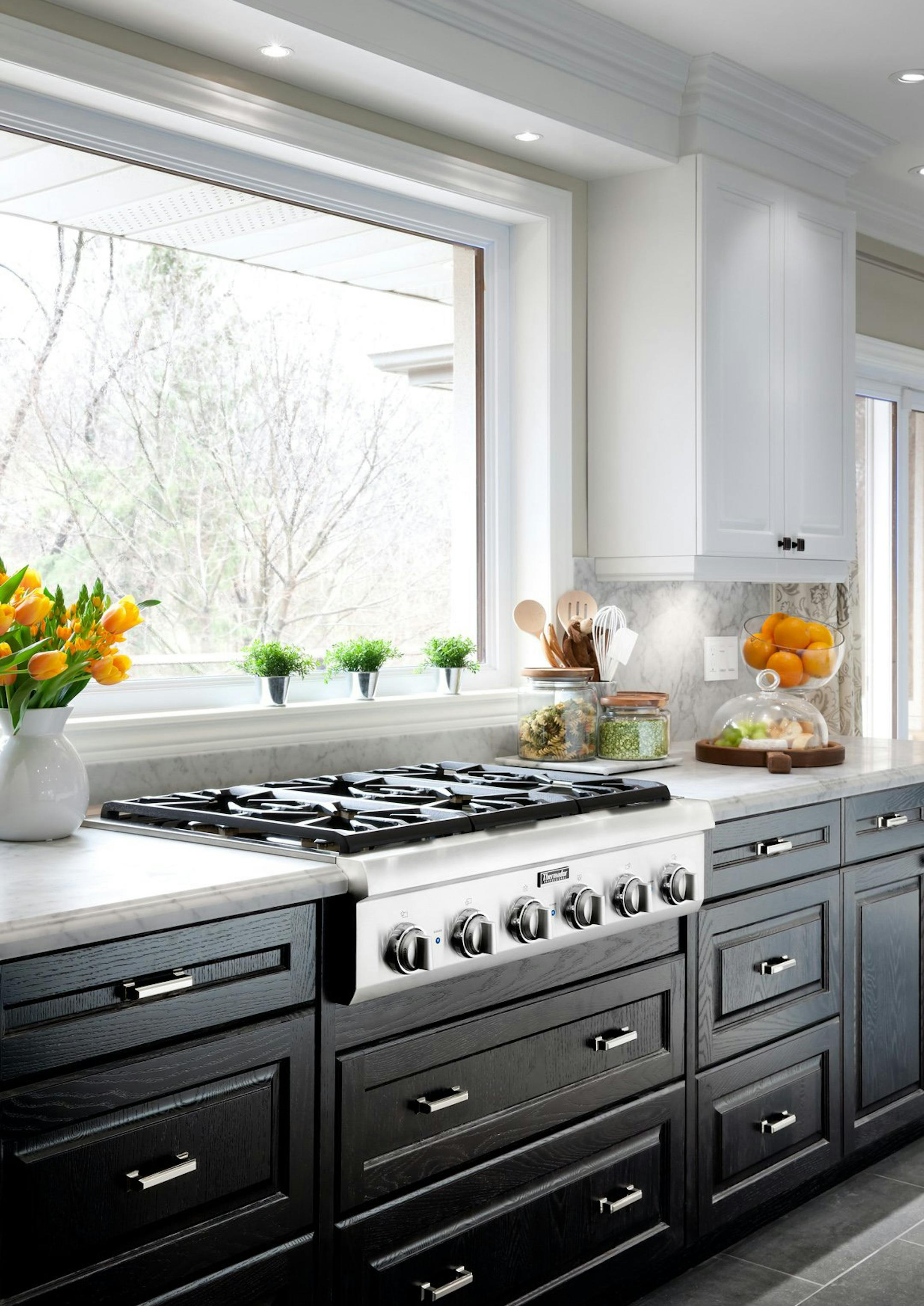 The counters are a beautiful honed marble - a sealed white stone with grey veining - which was the perfect choice for both counters and backsplash. The marble is complemented by cabinetry in two different tones: oyster for the upper cabinets, contrasted sharply with an ebony oak finish for the lower cabinets. (MCT) ORG XMIT: 1154071