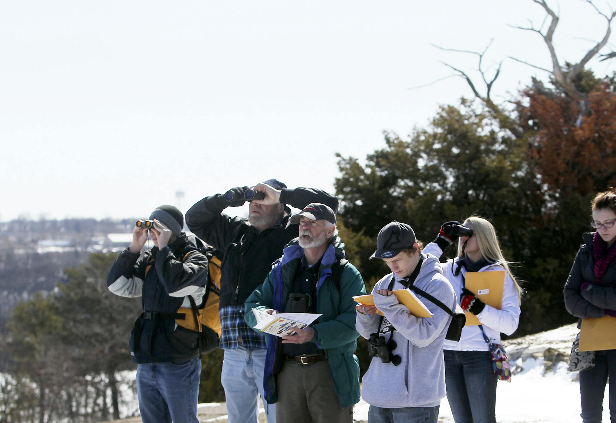 Carpenter Nature Center birding guide volunteer Kevin Smith, center, led birders and some Hastings High students involved in a bird-count competition on an outing aSaturday, April 20, 2013, at Carpenter Nature Center in Hastings, MN.](DAVID JOLES/STARTRIBUNE) djoles@startribune.com For the runup to Earth Day, Carpenter Nature Center in Hastings held a bird-count competition for kids Saturday, with kids fanning out to popular bird migration sites around the SE metro and at Carpenter Nature Center