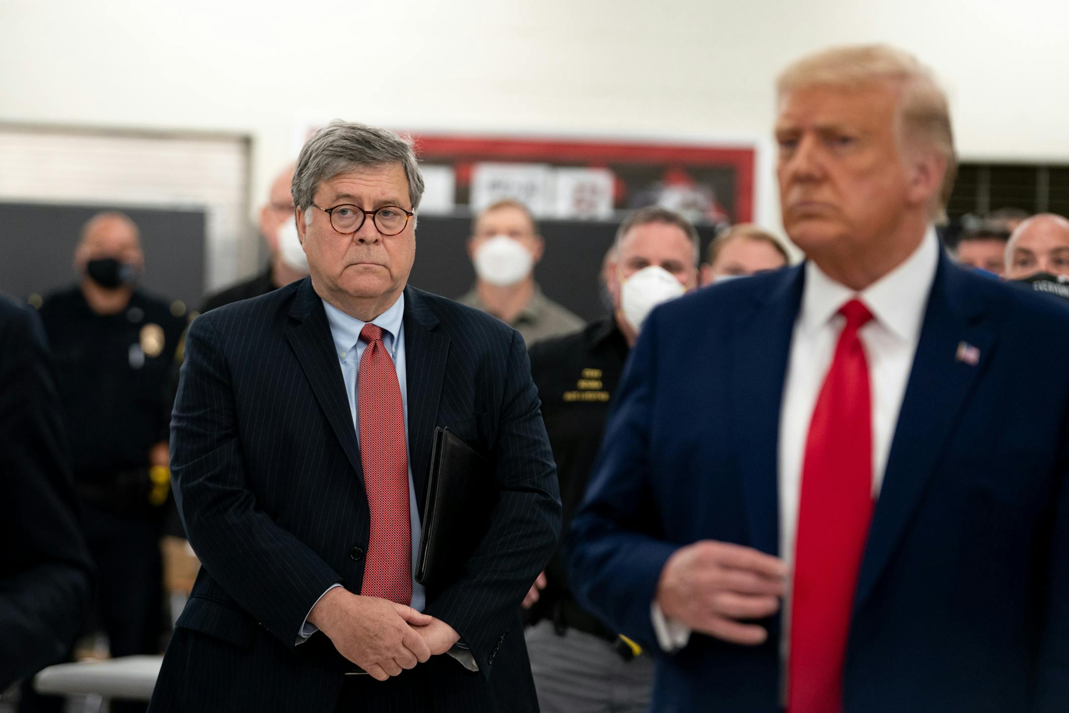 Attorney General William Barr listens as President Donald Trump speaks to law enforcement officers in Kenosha, Wis., Sept. 1, 2020. Barr sidestepped questions on Wednesday about President TrumpÕs incendiary conspiracy theory about a plane Òloaded with thugsÓ headed to Washington over the weekend, saying that he did not know Òwhat the president was specifically referring to,Ó but that the F.B.I. was investigating myriad reports that outsiders had traveled to the city to cause trouble. (Anna Money