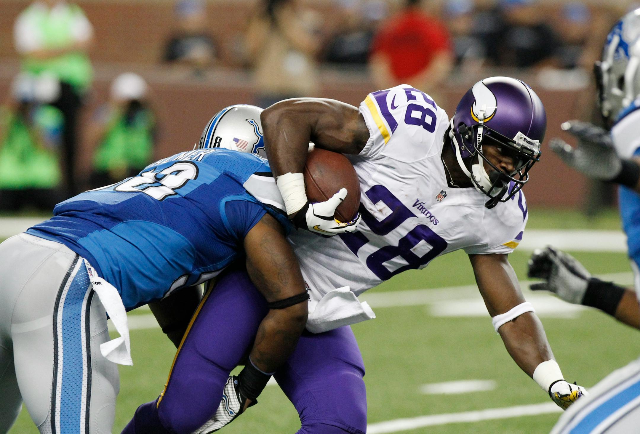 Minnesota Vikings running back Adrian Peterson (28) is stopped by Detroit Lions outside linebacker Ashlee Palmer (58) during the first quarter of an NFL football game at Ford Field in Detroit, Sunday, Sept. 8, 2013. (AP Photo/Duane Burleson)