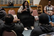 Sharletta Evans, sitting next to a photo of her son who was killed in a drive-by shooting 27 years ago, speaks with juvenile offenders at a Denver chu