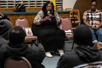 Sharletta Evans, sitting next to a photo of her son who was killed in a drive-by shooting 27 years ago, speaks with juvenile offenders at a Denver chu