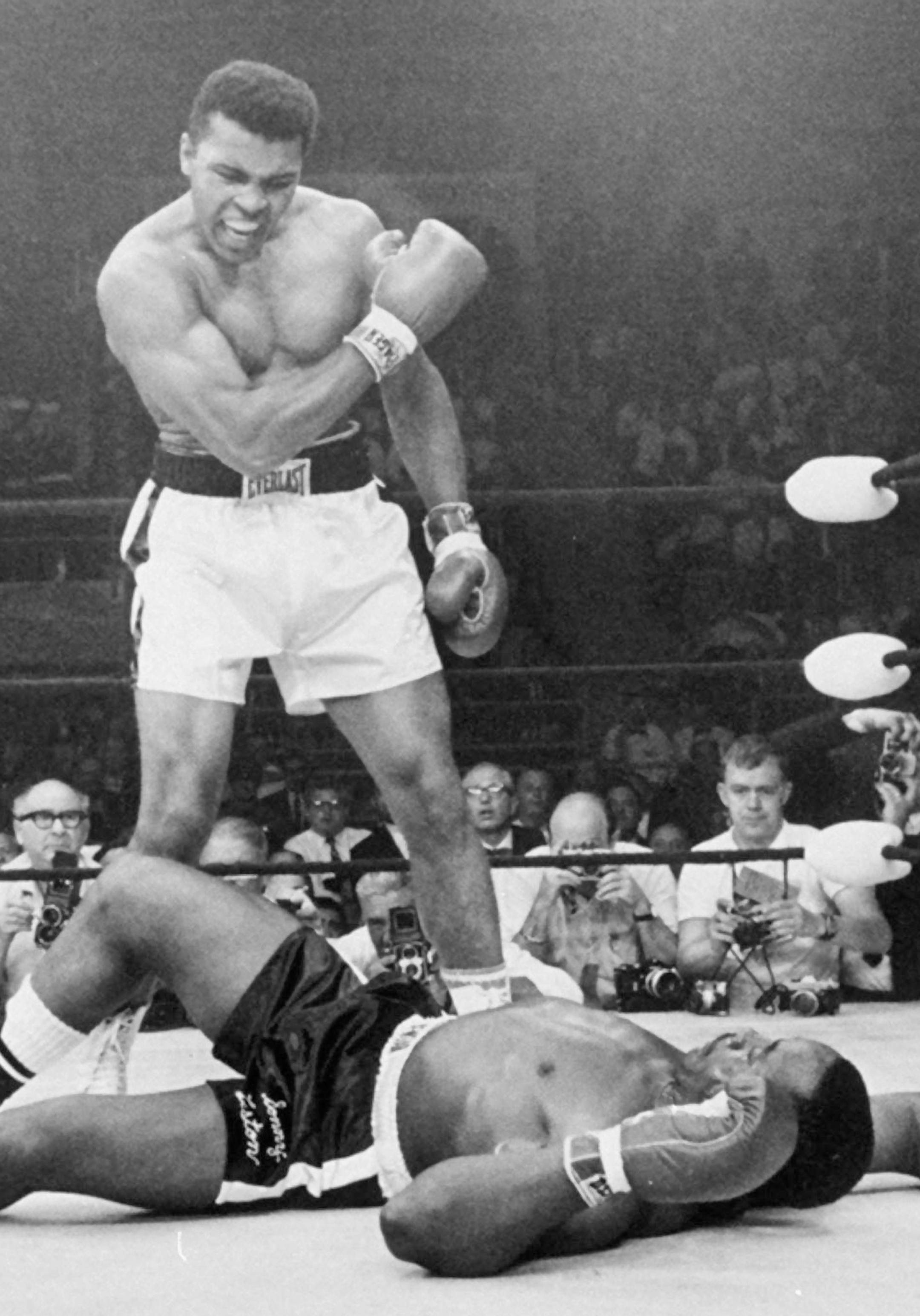 FILE - In this May 25, 1965, file photo, heavyweight champion Muhammad Ali, then known as Cassius Clay, stands over challenger Sonny Liston, shouting and gesturing shortly after dropping Liston with a short hard right to the jaw, in Lewiston, Maine. Ali, the magnificent heavyweight champion whose fast fists and irrepressible personality transcended sports and captivated the world, has died according to a statement released by his family Friday, June 3, 2016. He was 74. (AP Photo/John Rooney, Fil