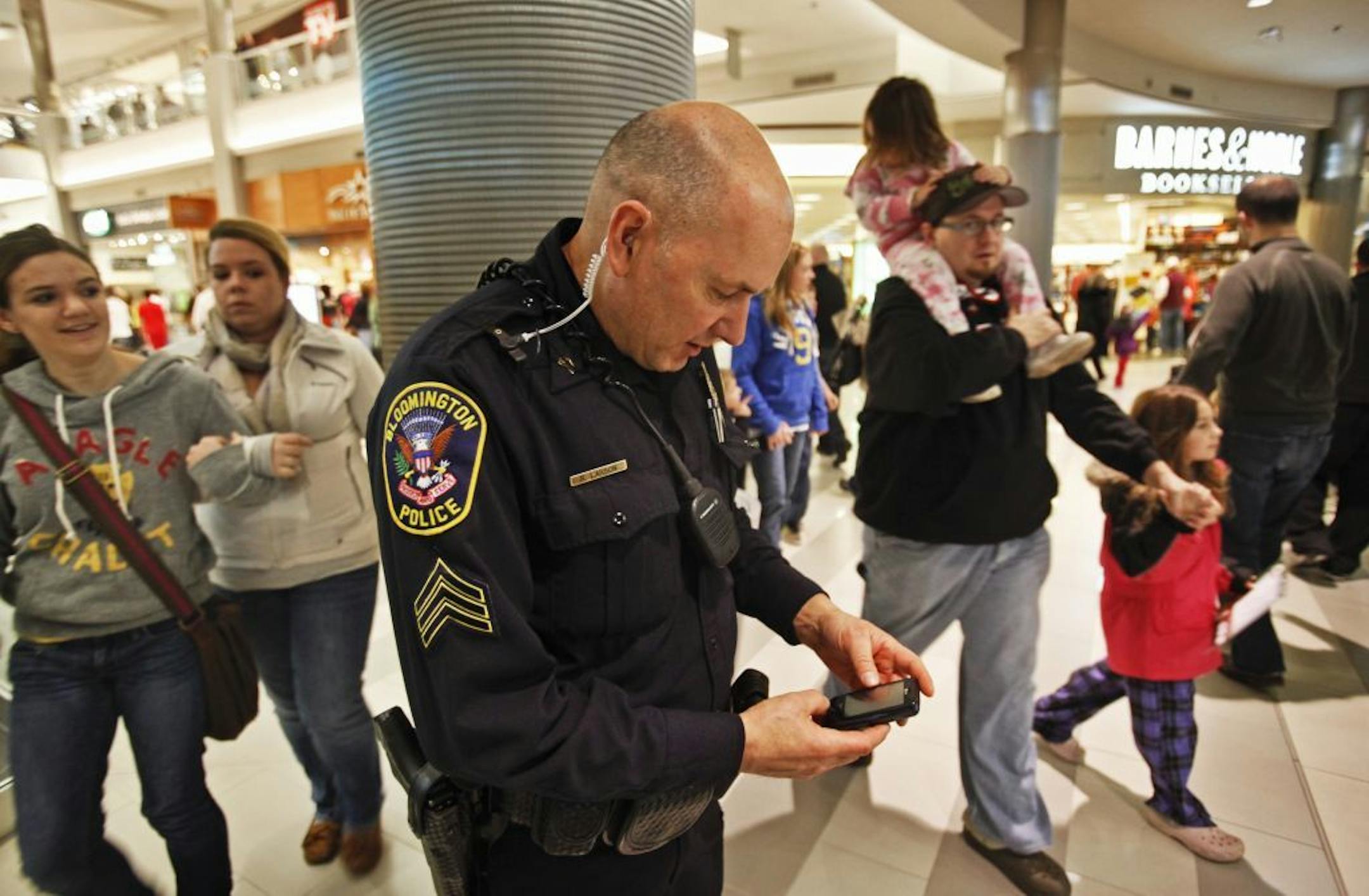 Bloomington Police sgt. Robert Larson checked his phone as he patrolled the MOA Tuesday, Dec. 27, 2011 in Bloomington, MN.