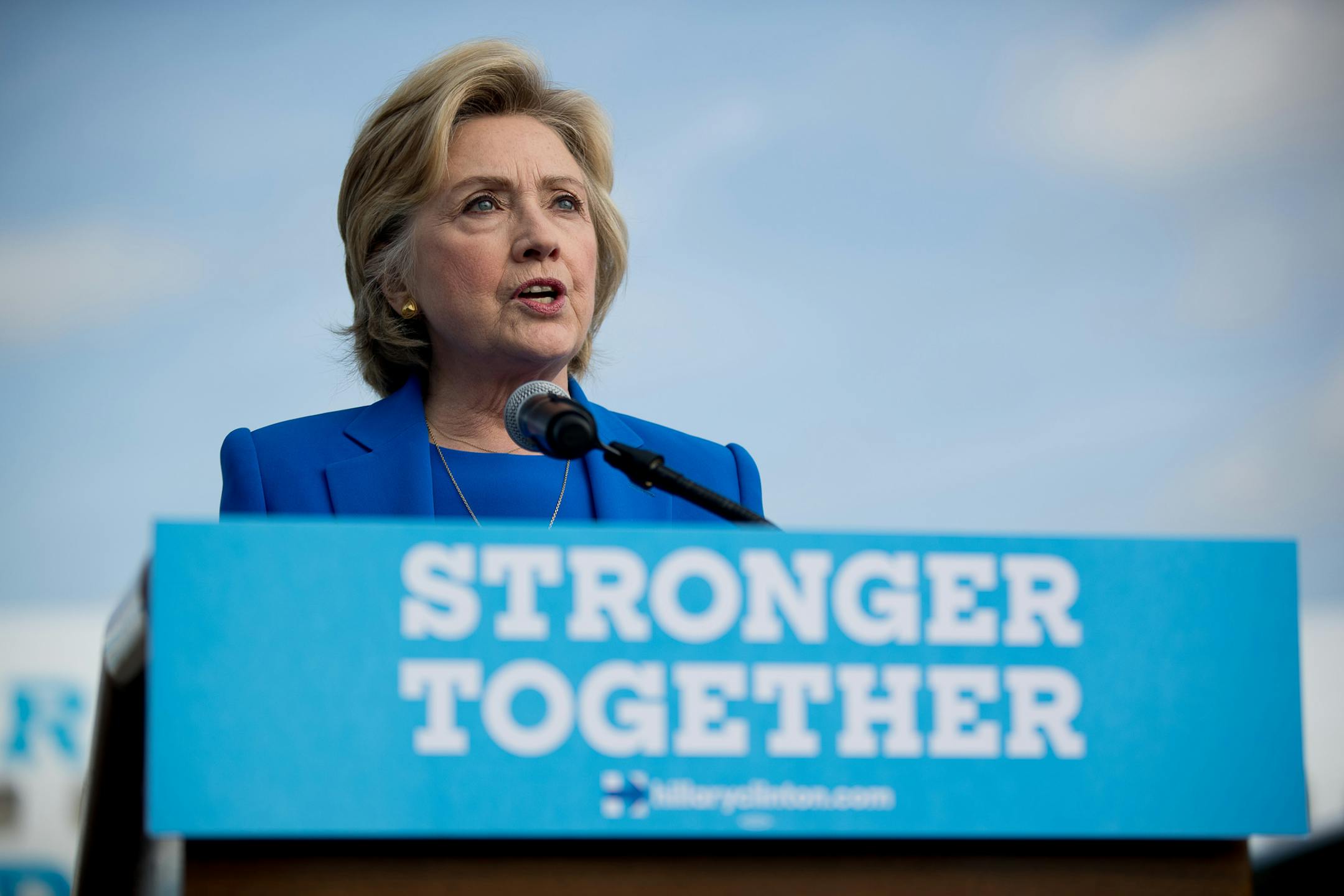 In this photo, Hillary Clinton speaks to members of the media before boarding her campaign plane at Westchester County Airport in White Plains, N.Y. on Sept. 8, 2016, to travel to Charlotte, N.C., to attend a campaign rally.