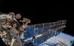 In a photo provided by NASA, the cosmonauts Oleg Artemyev and Sergey Prokopyev installe an antenna on the International Space Station in 2018 to track