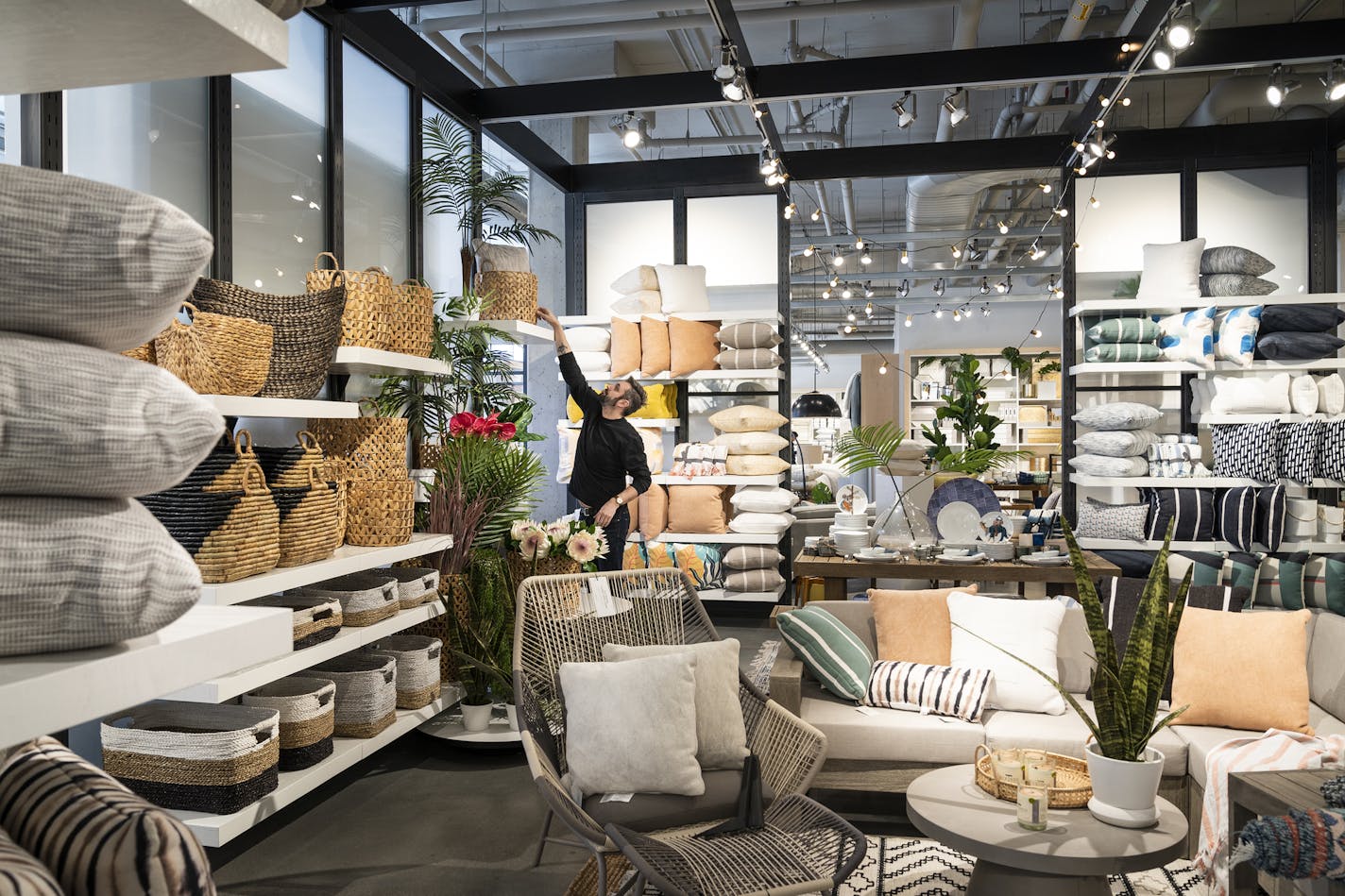 Scott Davis, the visual lead for the opening of the new West Elm in the North Loop, arranged an outdoor furniture and decor display. (LEILA NAVIDI &#x2022; leila.navidi@startribune.com)