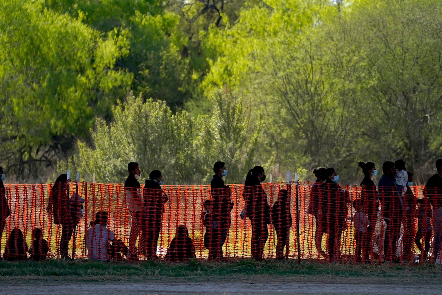 FILE - In this Friday, March 19, 2021, photo migrants are seen in custody at a U.S. Customs and Border Protection processing area under the Anzalduas International Bridge in Mission, Texas. The Biden administration is facing growing questions about why it wasn't more prepared for an influx of migrants at the southern border. The administration is scrambling to build up capacity to care for 14,000 young undocumented migrants now in federal custody — and more likely on the way. (AP Photo/Julio Cortez, File)