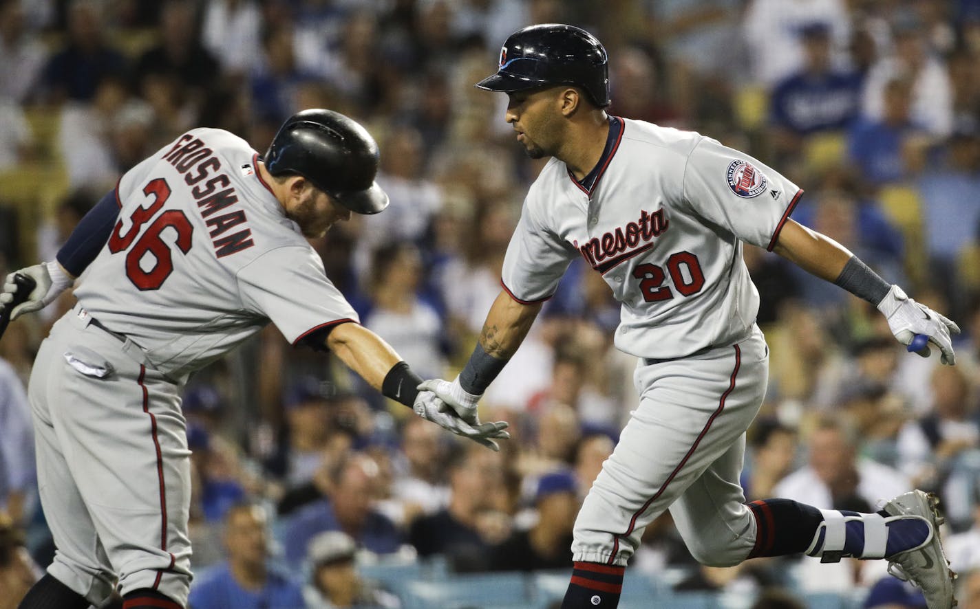 Minnesota Twins' Eddie Rosario, right, celebrates his home run with Robbie Grossman during the sixth inning of a baseball game against the Los Angeles Dodgers, Monday, July 24, 2017, in Los Angeles. (AP Photo/Jae C. Hong)