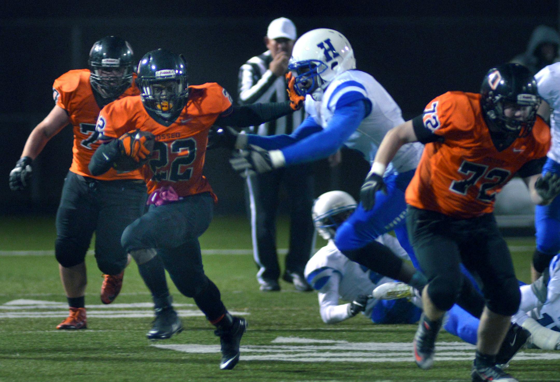 Osseo senior Prince G Kruah runs the ball during the first half of the Class 6A football game Friday night at Osseo High School. Osseous led Hopkins 21-14 at halftime. ] (SPECIAL TO THE STAR TRIBUNE/BRE McGEE) **Prince G Kruah (orange, 22) ORG XMIT: MIN1510232034223529