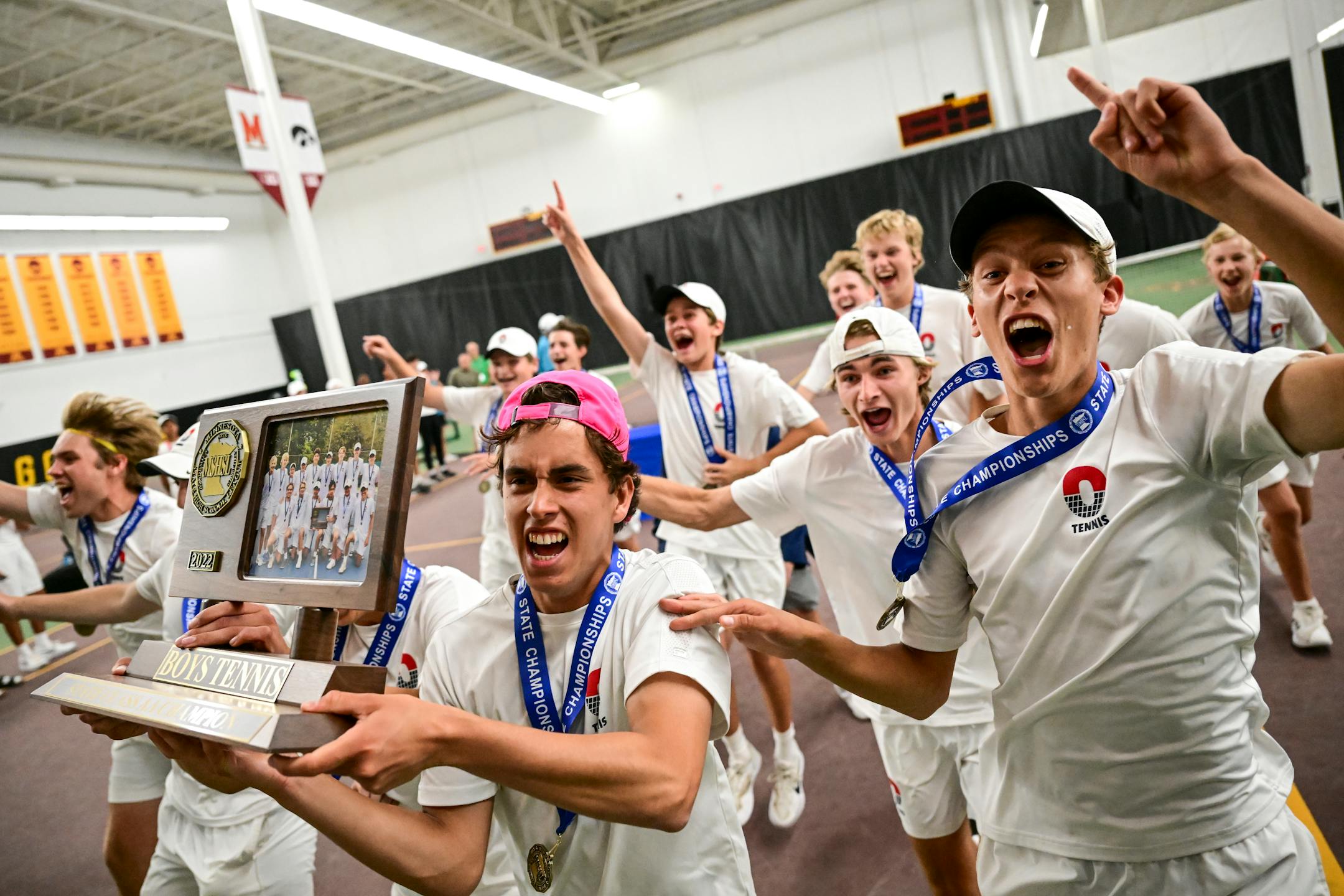 Orono players, including team captain Matias Maule, left, celebrate with their trophy after defeating Edina in the 2A final for the team state championship in boys' tennis Wednesday, June 8, 2022 at the University of Minnesota's Baseline Tennis Center in Minneapolis, Minn. ] Aaron Lavinsky • aaron.lavinsky@startribune.com